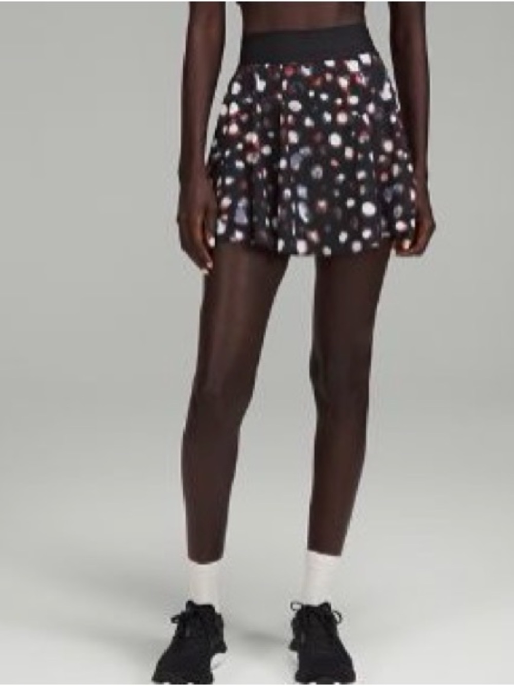 lululemon black skort with orange and white abstract spots
